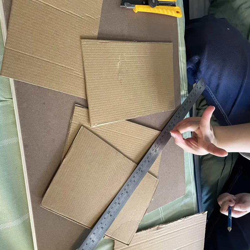 Process of cutting out the cardboard pieces for our second prototype.
